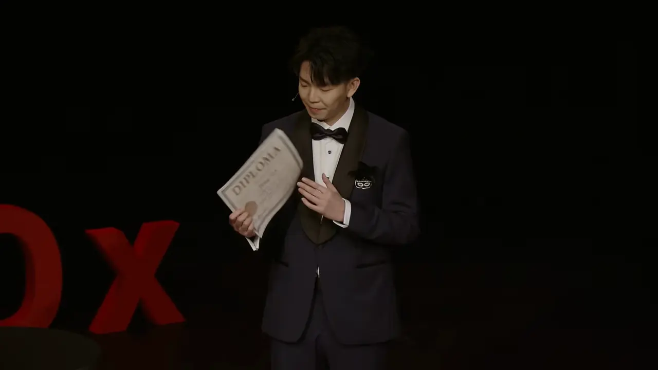 Johnny Wu on the TEDxBeverlyGrove stage holding the diploma from the start of his talk